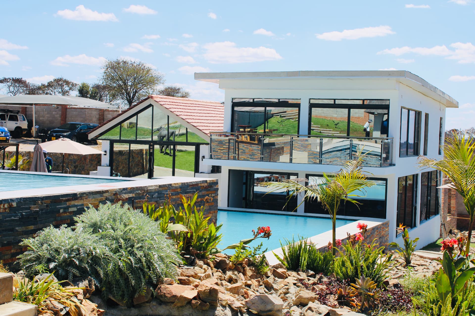 The Lions Gate buildings, gardens and pool under a blue sky